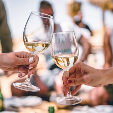 two women holding glass of champagnes